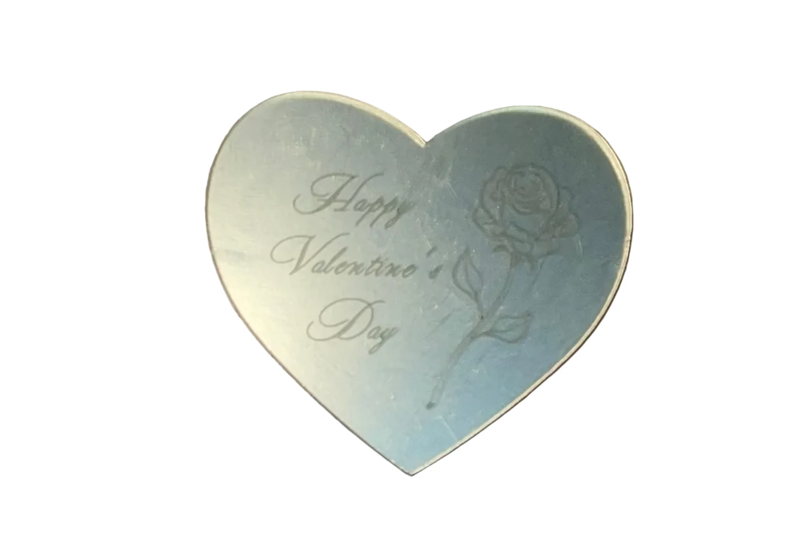 Gold heart-shaped card on a gold surface with 'Happy Valentine's Day' text.